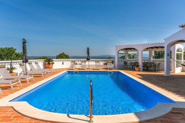 Poolside relaxation with terrace and sun loungers