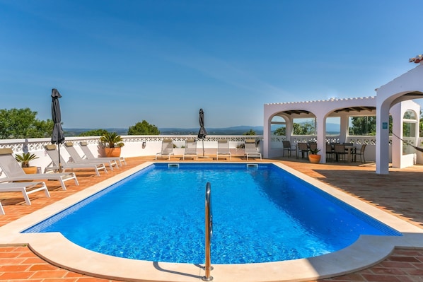 Poolside relaxation with terrace and sun loungers