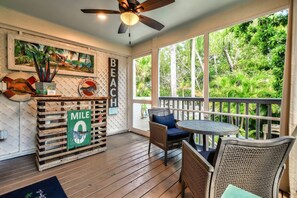 Unwind on the screened back porch, where gentle island breezes and the sounds of nature create the perfect setting for relaxation.