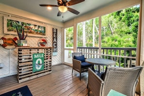 Unwind on the screened back porch, where gentle island breezes and the sounds of nature create the perfect setting for relaxation.