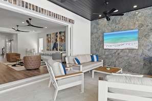Huge doors open for indoor/outdoor living off of the ground floor, including an outdoor television.