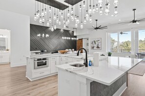 Custom lighting and a fully equipped kitchen.