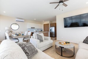 Spacious living room with breathtaking 180-degree ocean views!  Designed for relaxation, this open-concept space features comfortable seating, a TV, and plenty of natural light — perfect for unwinding after a day of exploring.