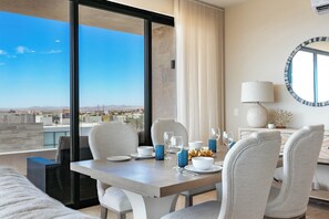 Dining area with stunning ocean views, offering a picturesque setting for every meal. Enjoy a comfortable and inviting space where you can dine while taking in the beautiful scenery.