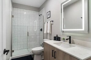 You feel a sense of calm as you enter the bathroom, where the thoughtful design and high-quality materials create a serene environment.