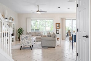 Living room open to large screened-in porch