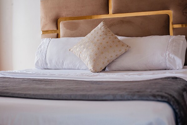 Stylish Double Bed with Velvet Headboard & Soft Lighting