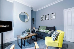 The spacious open-plan living space benefits from a double sofa bed, a 40-inch smart TV and plenty of space to sit down and relax.