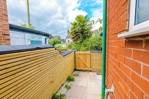 To the rear of the property, there is a small patio area, perfect for getting some fresh air.