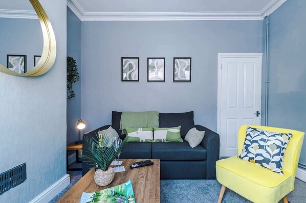 The spacious open-plan living space benefits from a double sofa bed, a 40-inch smart TV and plenty of space to sit down and relax.