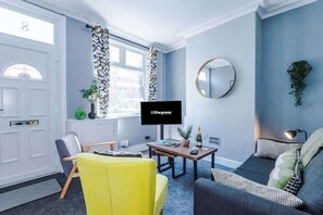 The spacious open-plan living space benefits from a double sofa bed, a 40-inch smart TV and plenty of space to sit down and relax.