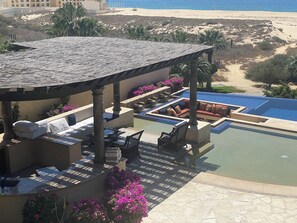 Upstairs view of Grill, seating area, pool and fire pit