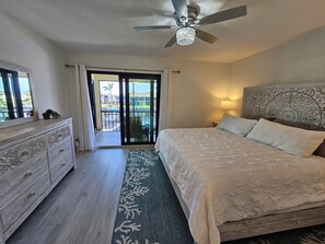 Large master bedroom with King bed overlooking the water.