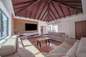 Air-conditoned  living room with HD-TV, DVD player, Dish Network satellite, iPod dock, ceiling fan. 