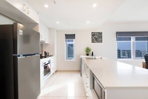 Cook up a storm in the fully equipped kitchen, complete with an oven, microwave, dishwasher, and stone benchtops. 