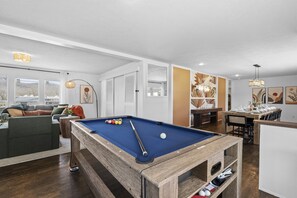 Unwind with a game of pool in this inviting space, where fun and relaxation come together with cozy seating and plenty of natural light.