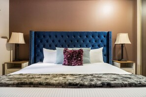 Primary bedroom, located downstairs, with a king bed, closet & blackout curtains.
