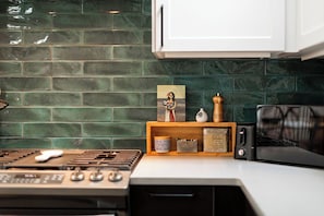 Range with vent, microwave, toaster, and a full spice drawer.