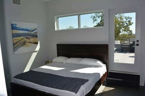 Master Bedroom with Walkin ensuite shower and bathroom with oversized walkin closet and slider onto patio and door ontop rooftop Terrace