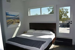 Master Bedroom with Walkin ensuite shower and bathroom with oversized walkin closet and slider onto patio and door ontop rooftop Terrace