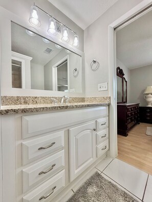 Master bath: Enclosed, all-tiled stand-up shower,vanity sink with mirror, toilet