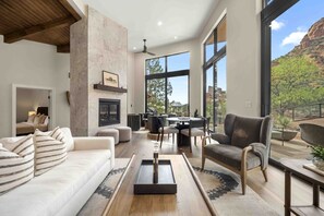 Large seating area with a fireplace and views