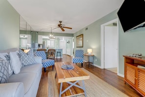 The open main living area includes a living room, dining area and kitchen.