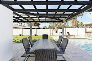 Host the perfect outdoor gathering with a bar for drinks and a dining area for meals.