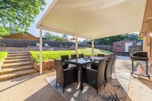 "Spacious backyard with grill and seating"