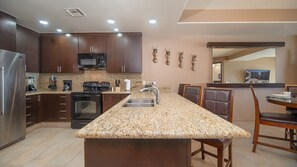 large kitchen with counter and full appliances