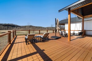 Take in the views from the spacious patio with lounge seating, a dining table, grill, and a fire pit.