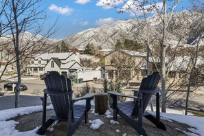 Adirondack chairs overlooking the mountains, located right outside of your door