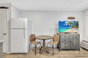 Gather around the small dining area, perfect for enjoying meals or planning your next island adventure.