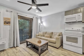 Relax in the cozy living room, featuring a plush pullout sofa and a large TV for movie nights.