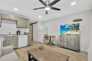 Enjoy your favorite shows on the large TV while lounging in this comfortable, coastal-inspired living room.