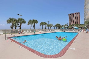 Large outdoor pool with ample suntanning area. 