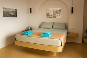 Peaceful Bedroom with Warm Lighting and Clean Linens
Thoughtfully arranged for restful nights in a serene Cycladic setting.