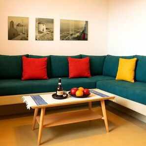Stylish Living Room with Bold Accents and Ample Seating
A warm and colorful space designed for relaxation after a day exploring Santorini.