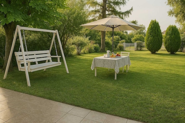 Lush Garden with Outdoor Swing and Table