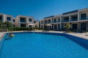 Two Shared Swimming Pools with Loungers

