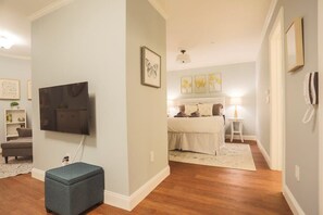Bed is separated with a wall, but no door to the rest of the apartment.