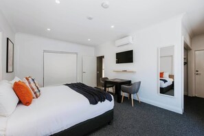 This suite features cozy seating and modern amenities, offering the perfect space to unwind and recharge during your stay.