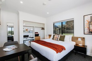 The suite has a kitchenette to prepare light meals and a table for dining or remote work.