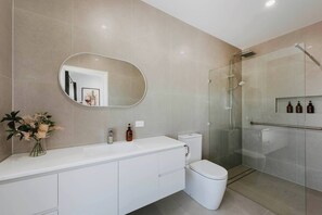 Freshen up in the spacious ensuite with a large vanity, walk-in shower, and complimentary toiletries. 