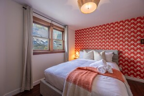 Unwind in this bright and stylish bedroom featuring a comfortable queen bed and vintage alpine design.