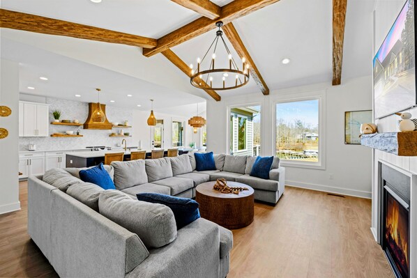 Unwind in this stunning lakefront retreat! Cozy up by the fireplace, relax on the plush sectional, and enjoy breathtaking views. With vaulted ceilings, wood beams, and designer touches, this open-concept space is perfect for making unforgettable memories!