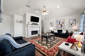 The living room has a fireplace and Roku TV
