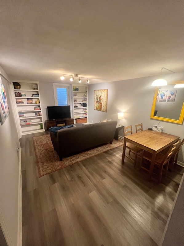 Cozy living room with Apple TV for streaming. Dining table for 4.