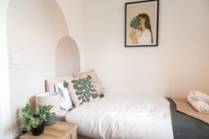 Features  comfortable single beds, ideal for guests, kids, or roommates—offering both privacy and a restful night's sleep.