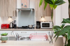 Fully equipped kitchen with modern appliances, ample counter space, and all essentials—perfect for cooking, dining, and everyday convenience.